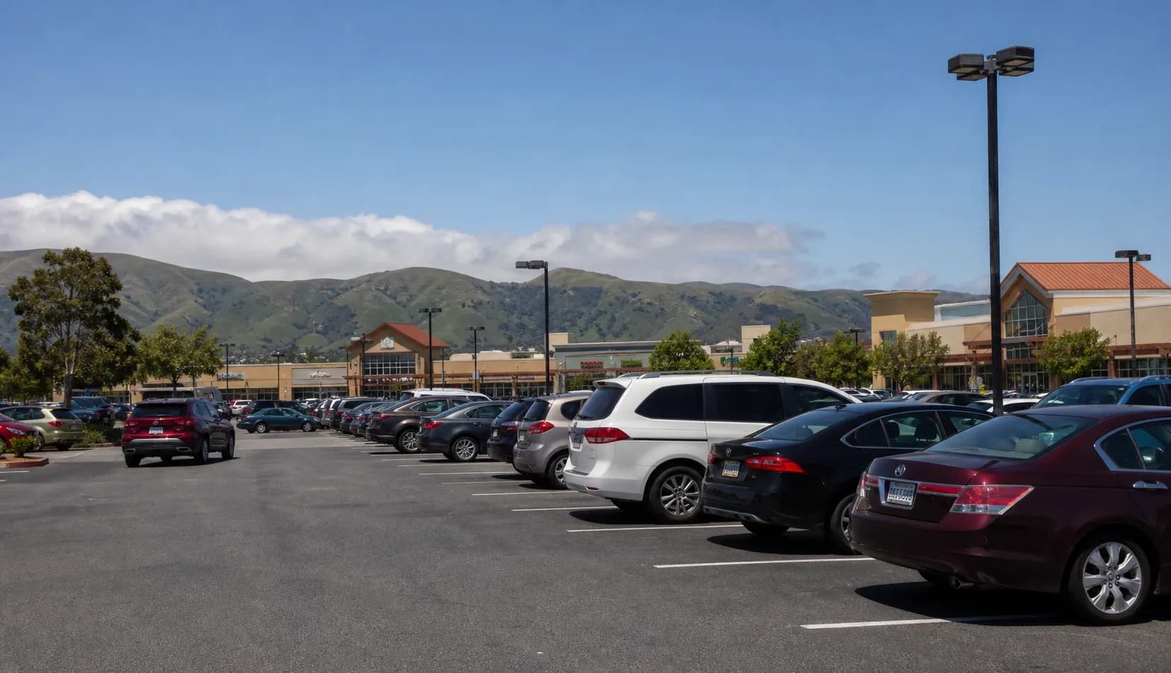 The parking area near the Daly City shopping district with the peninsula hills in the background.