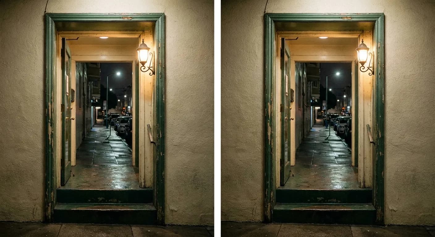 A recessed restaurant doorway below sidewalk level on a quiet San Francisco side street at night, lit by a single warm wall lamp