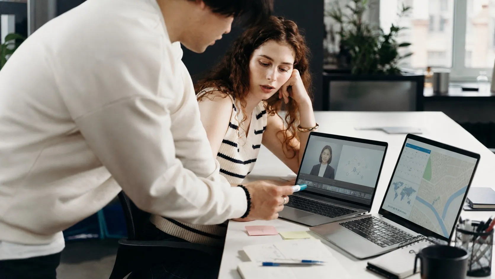 Colleagues building an AI training video while a city map and calendar frame the business trip