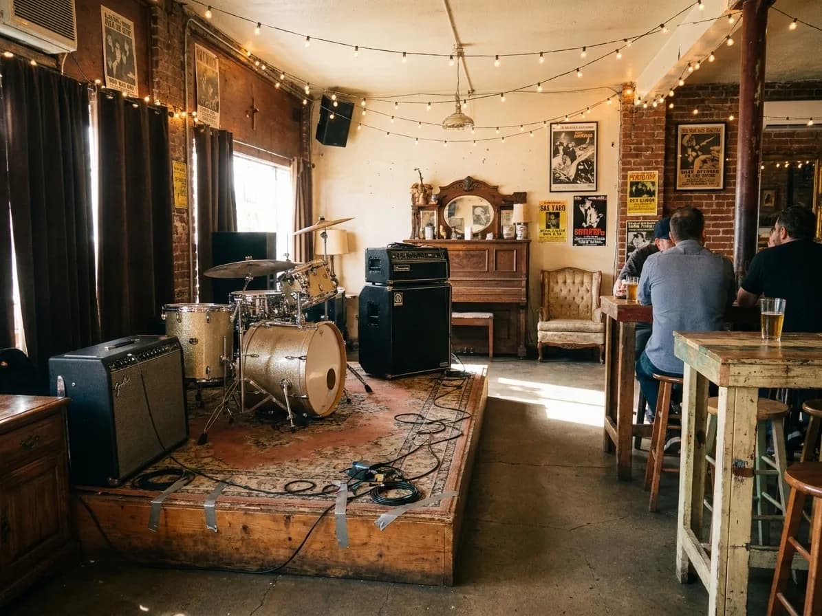 The back room of a Los Angeles bar set up for a band with amplifiers and a drum kit on a low riser