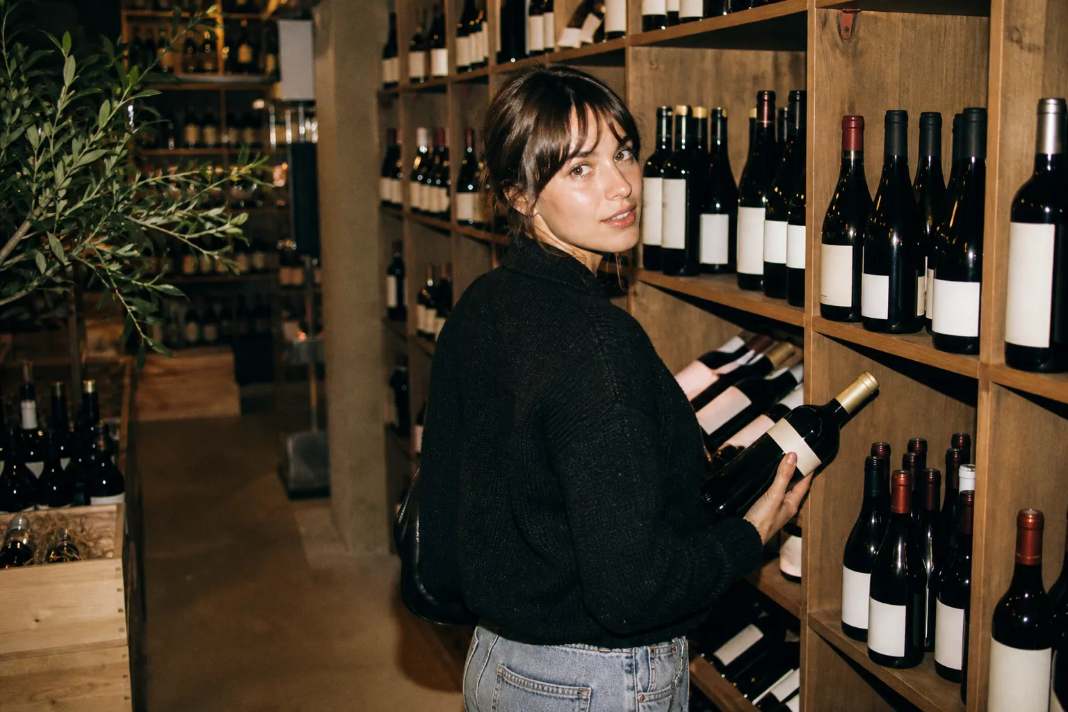 Tall shelves lined with wine bottles in a large, well-lit wine shop