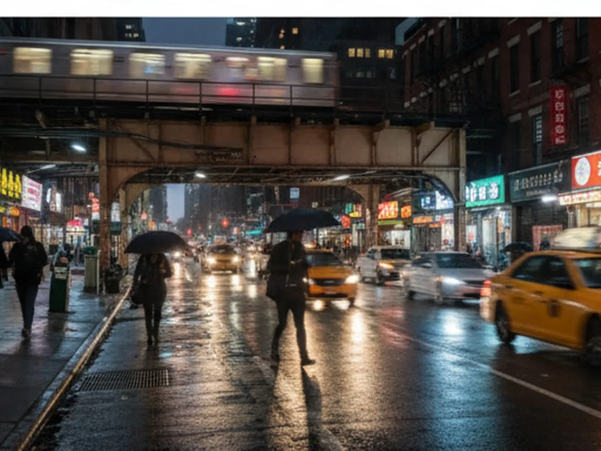 Inline photo two: Rainy night in Queens with blurred car headlights, elevated subway tracks overhead, and people with umbrellas walking past assorted restaurants, capturing the feel of searching for a warm fast-food stop in a typical outer-borough neighborhood.