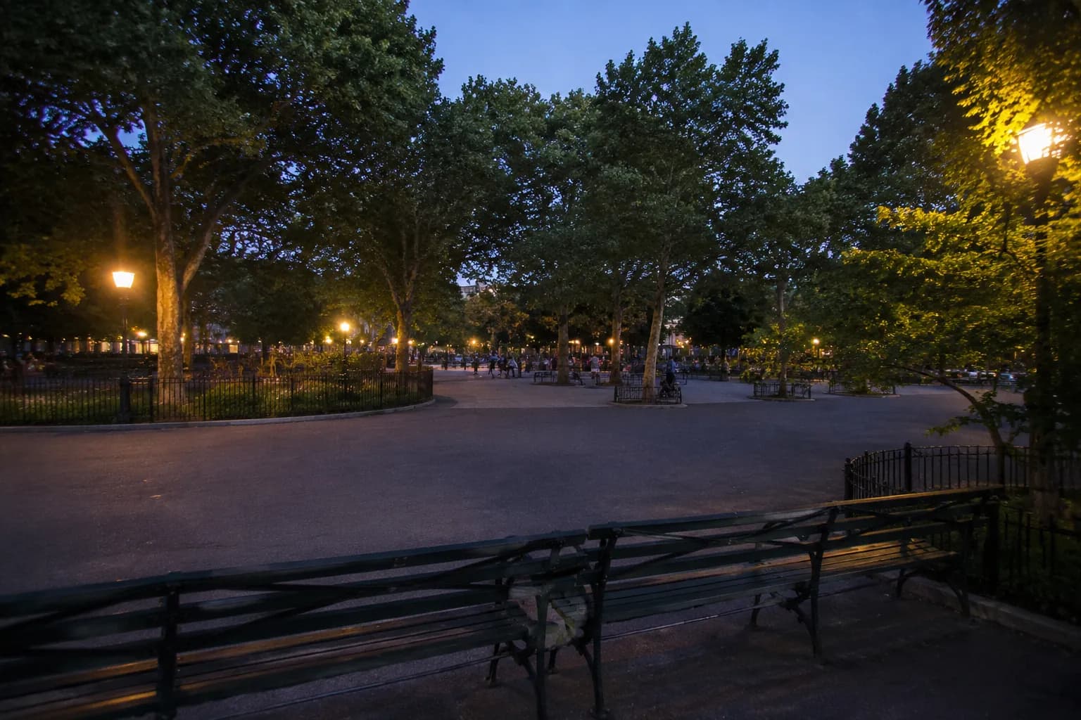 Maria Hernandez Park in Bushwick at dusk with benches, trees, and soft evening light