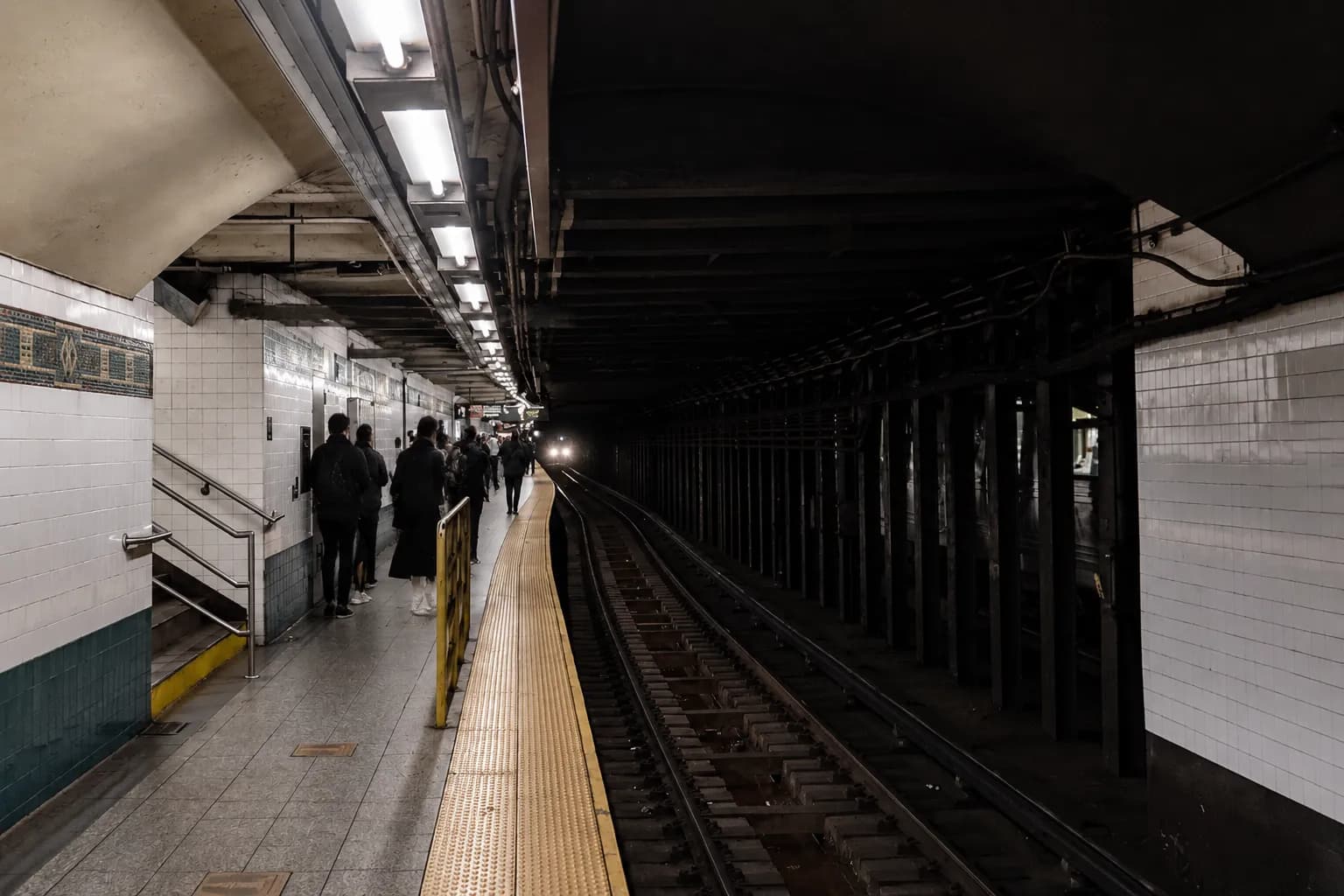 Canal Street subway platform in Manhattan with passengers waiting for a train