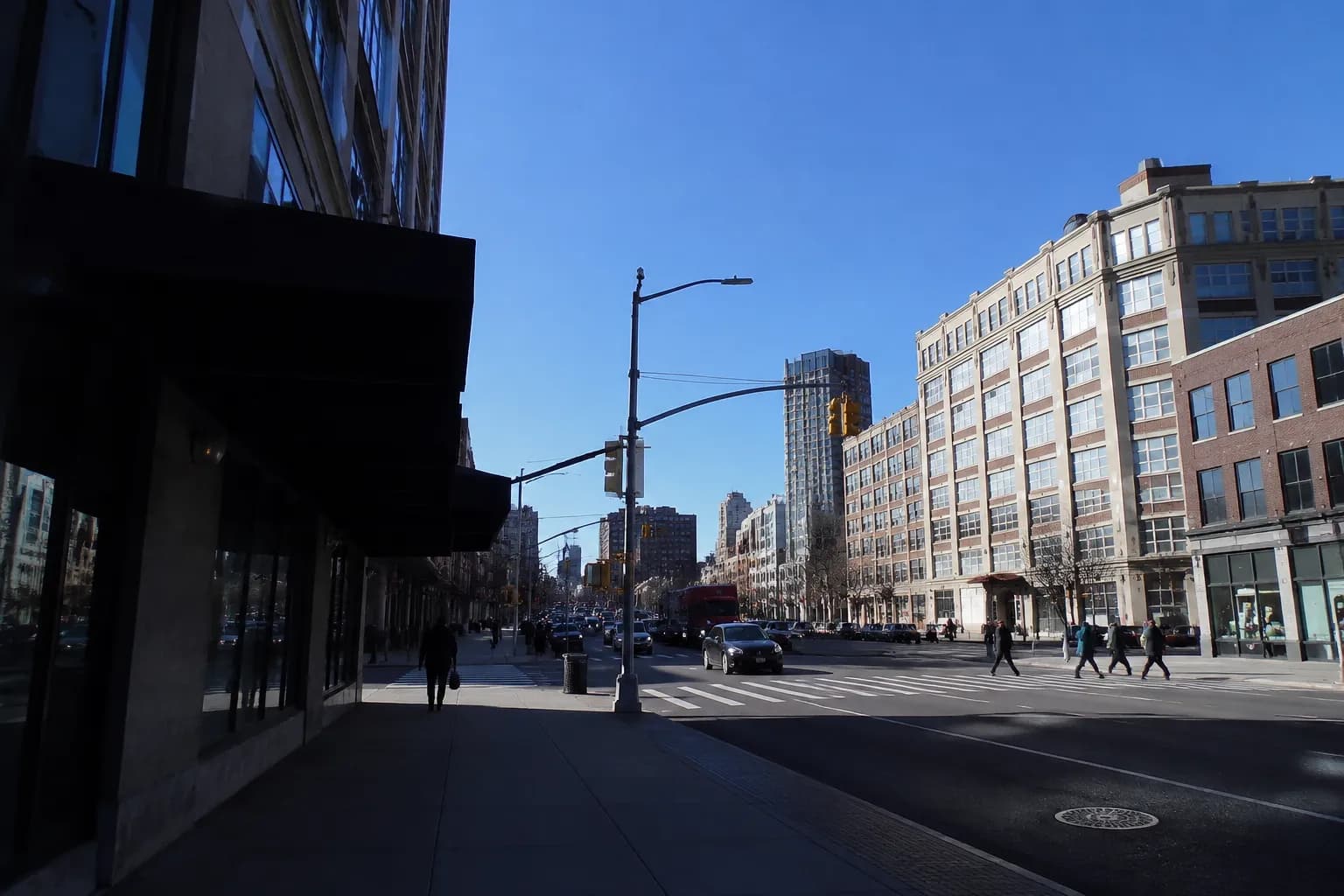 Flatbush Avenue Extension in downtown Brooklyn on a summer afternoon with pedestrians and storefronts