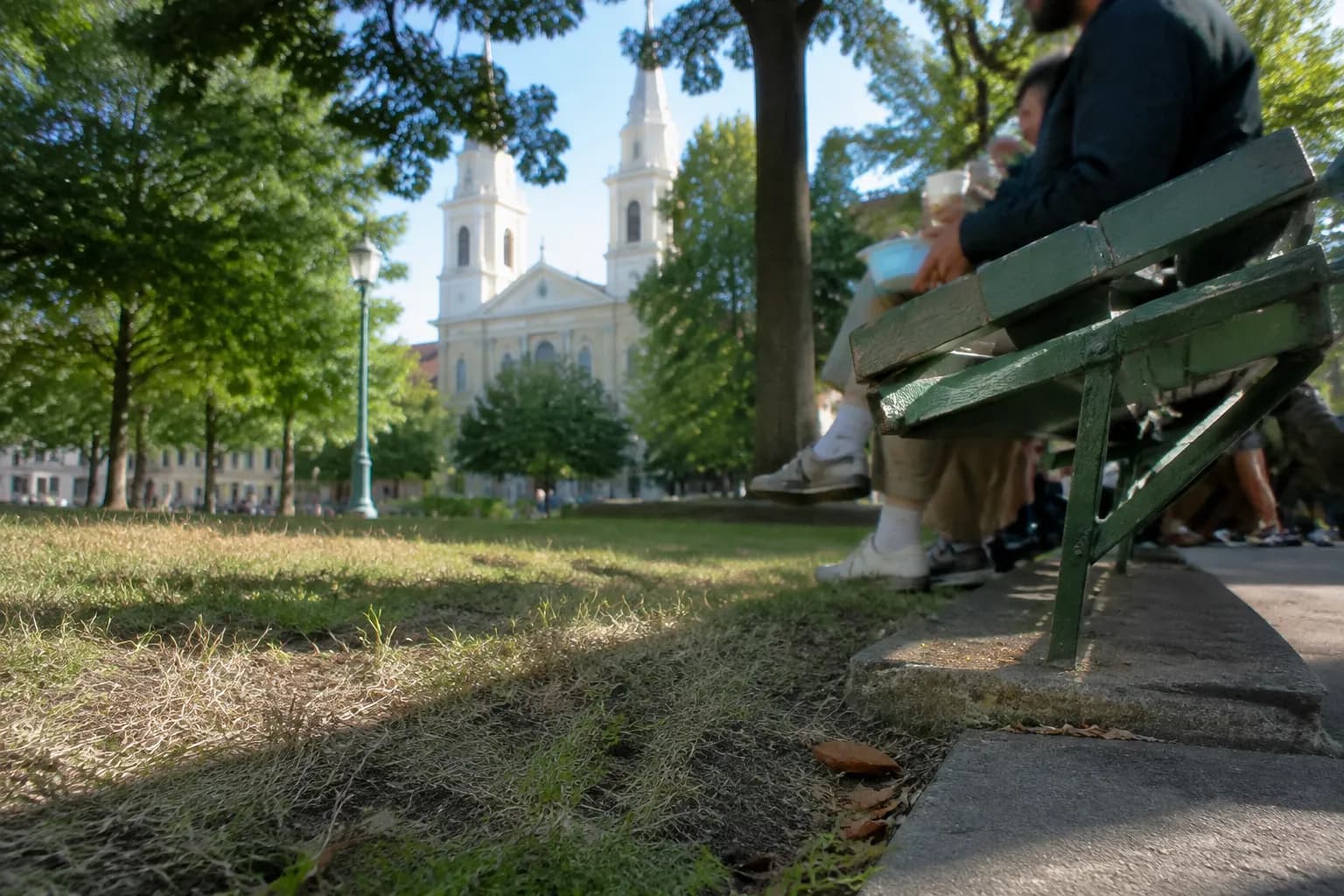 Southeast corner bench at Washington Square Park with church towers behind