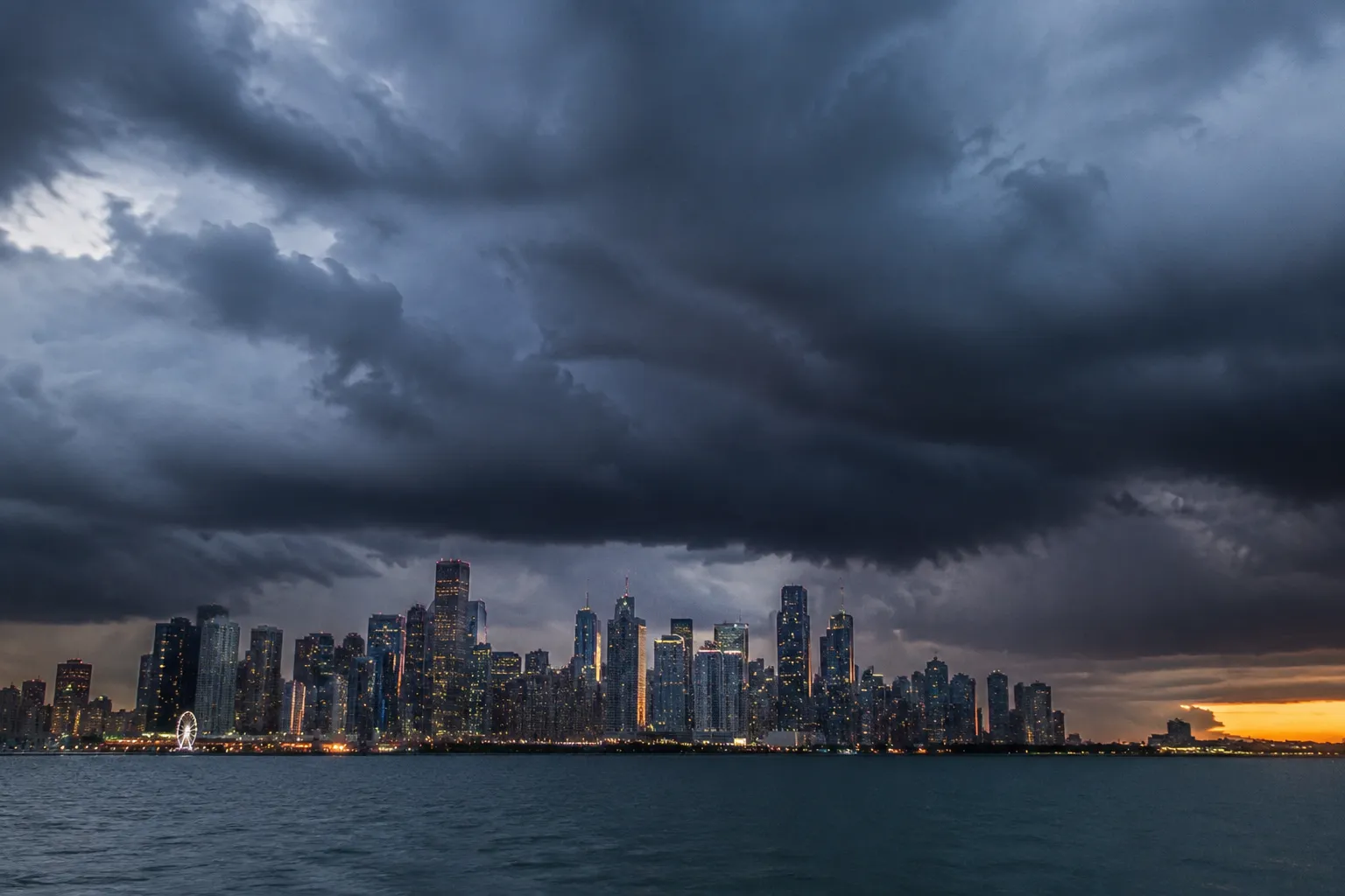 Dark summer storm clouds approaching the Miami skyline over Biscayne Bay at dusk