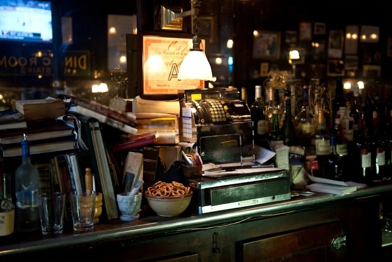 Warm wood back bar and bottle rows inside a classic New York City tavern