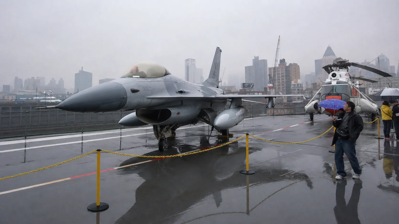 Visitors walking among historic aircraft on the Intrepid Museum flight deck in New York City.