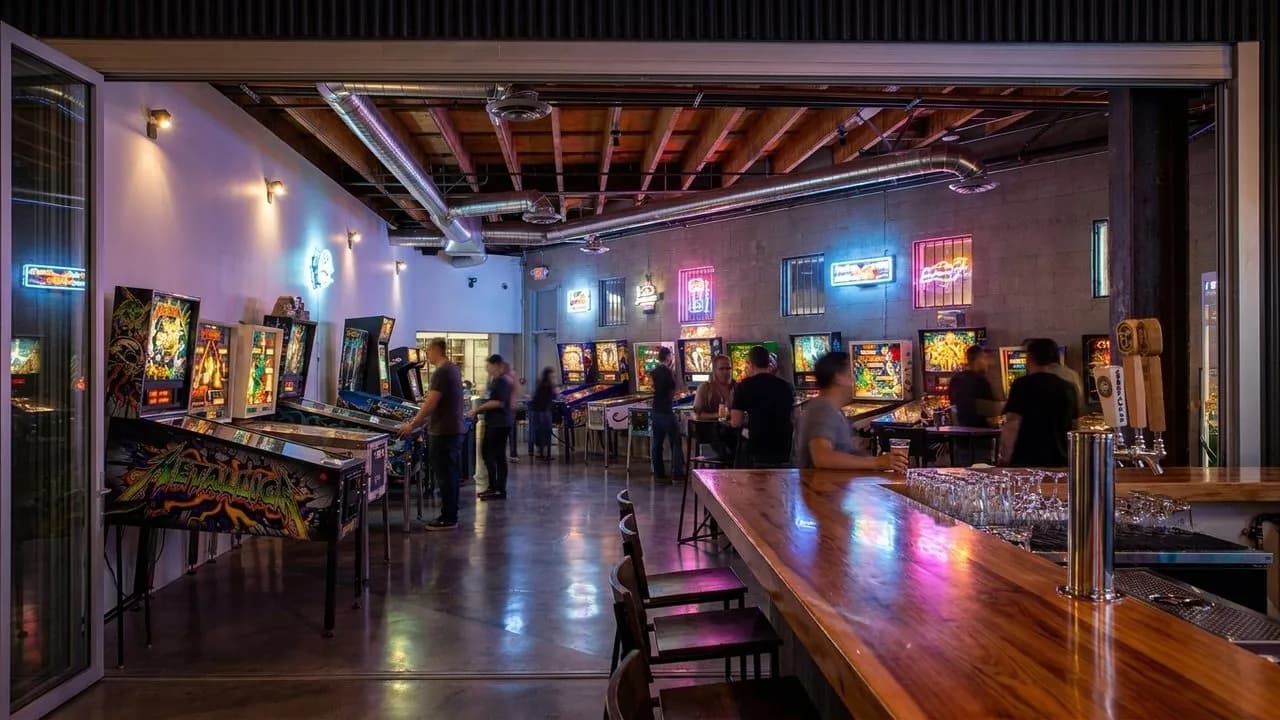 Neon arcade room with bar counter and classic cabinets