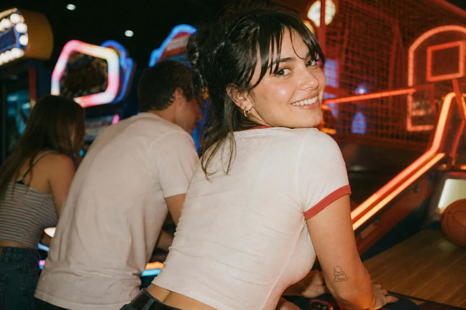 A lively arcade lit up with rows of neon game machines