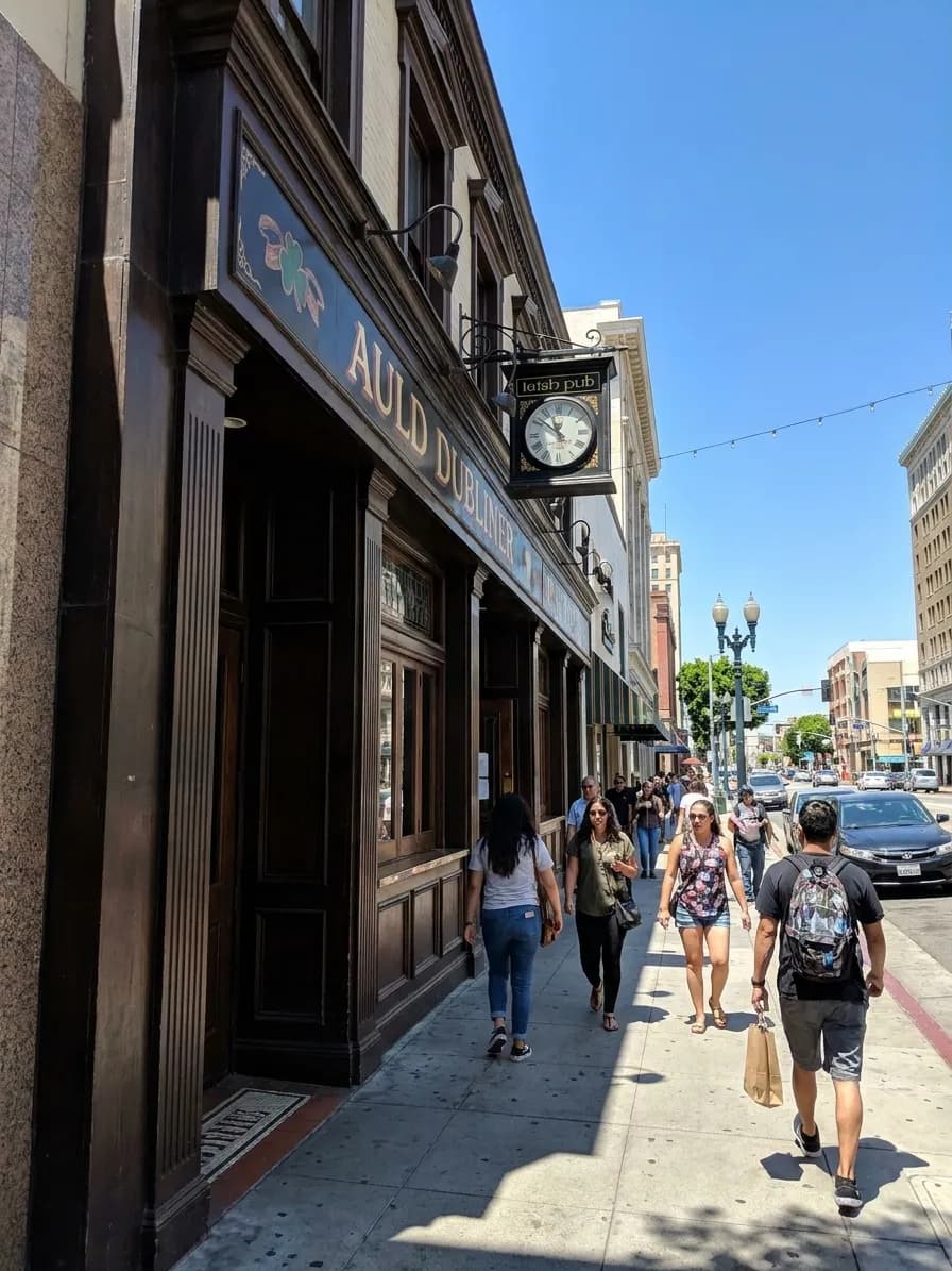 Auld Dubliner Irish pub exterior on Pine Avenue in downtown Long Beach with dark green facade and traditional pub signage