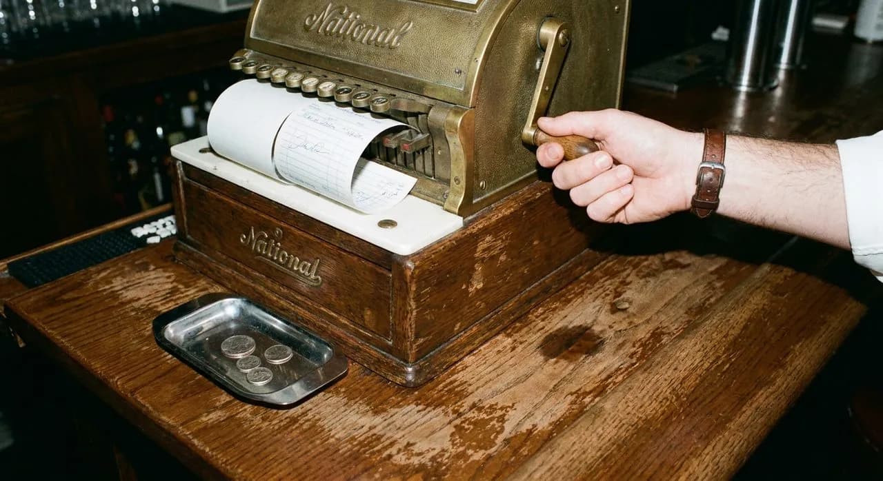 Bar seating at Peter's Since 1969 where the cash register still prints carbon receipts