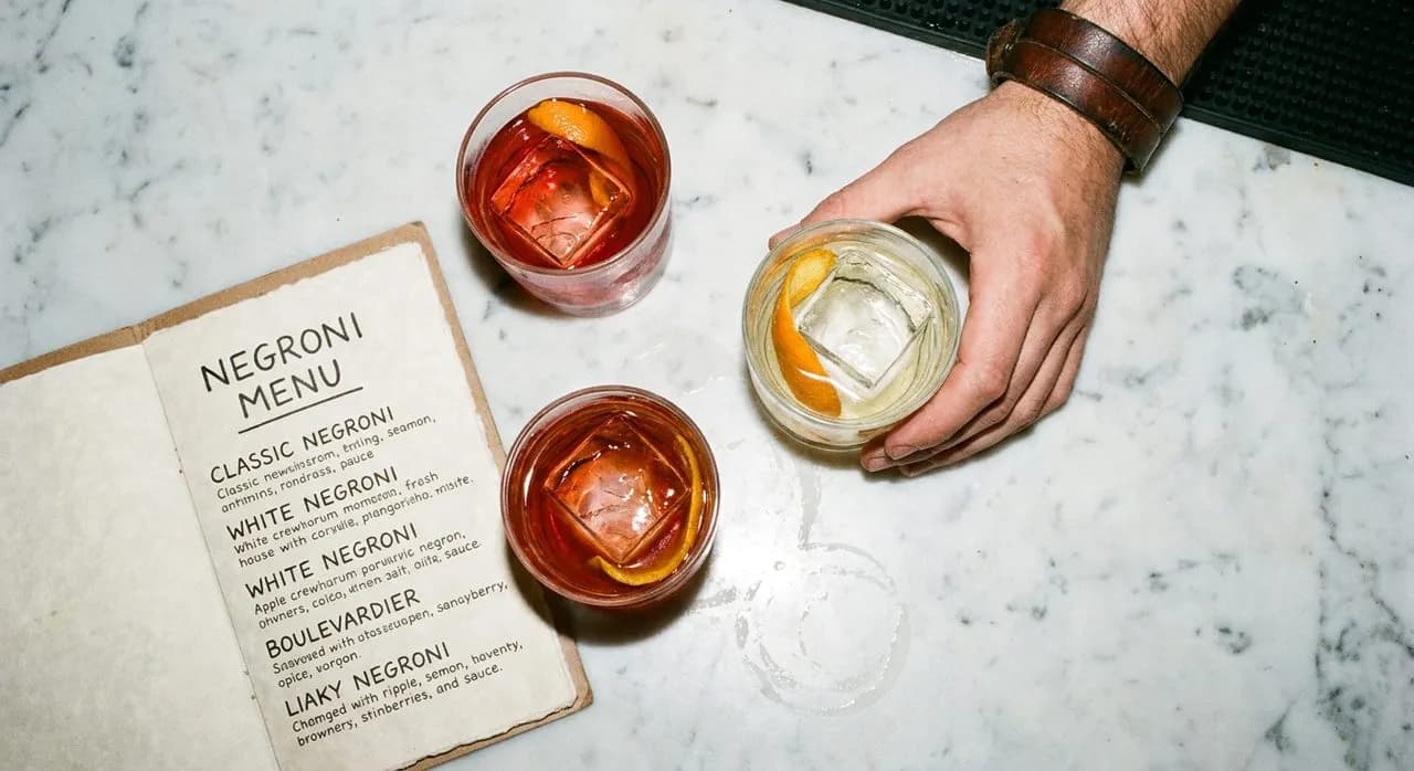 Bar stools at Dante where the Negroni menu lists twelve variations on the classic
