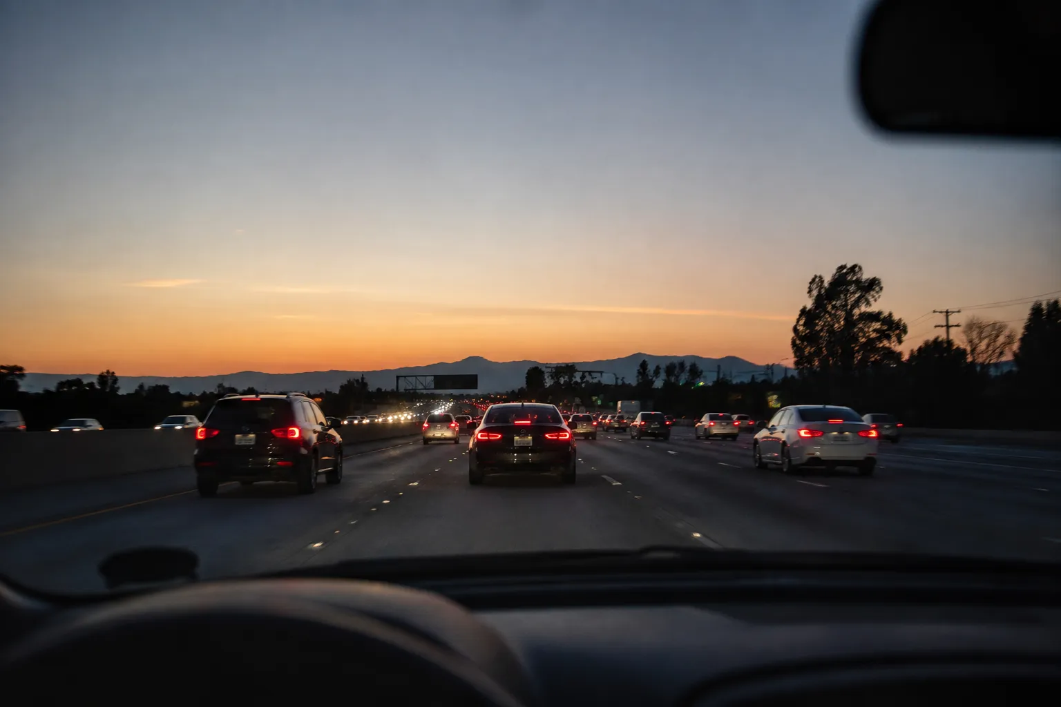 View through car windshield of evening traffic on the 210 freeway heading toward Arcadia