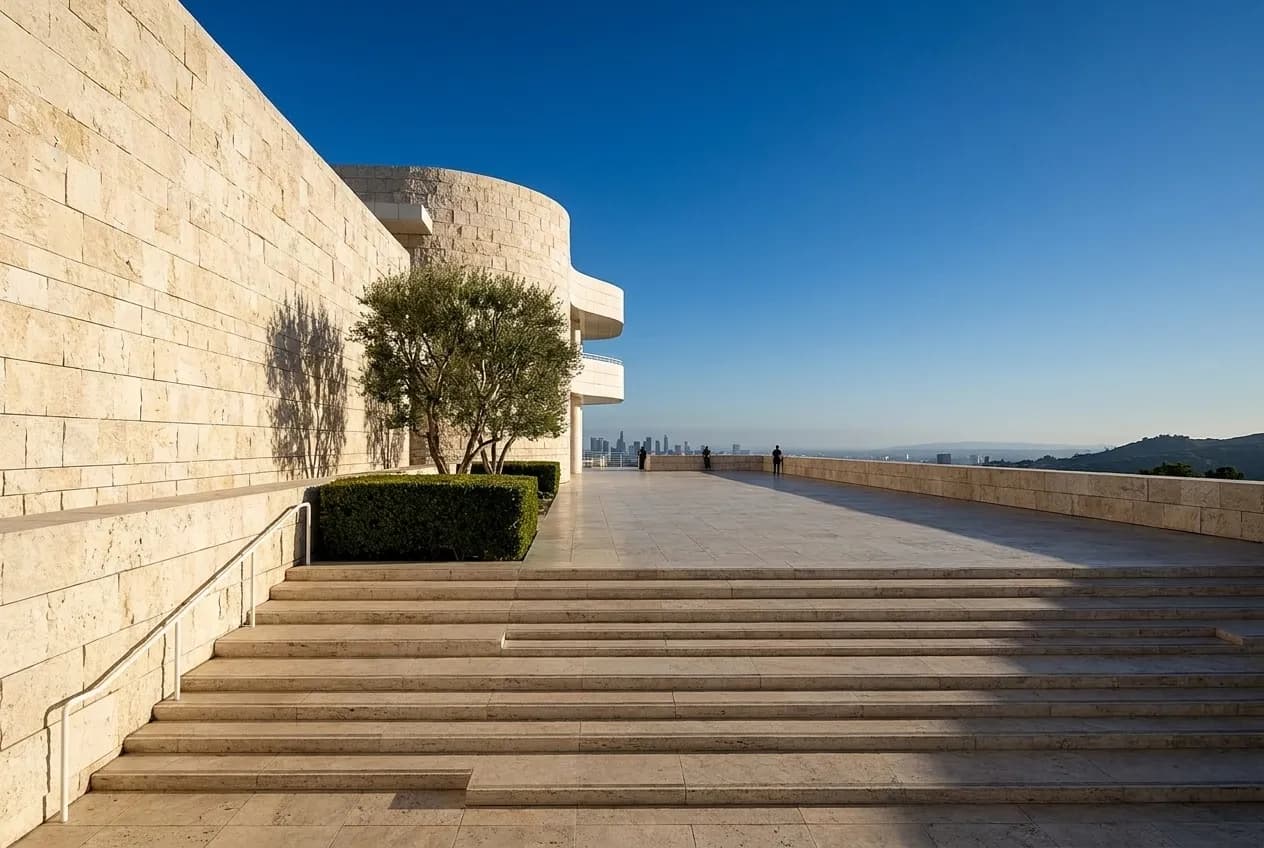 Pale stone terraces and a wide open plaza at a hilltop Los Angeles museum in strong afternoon light