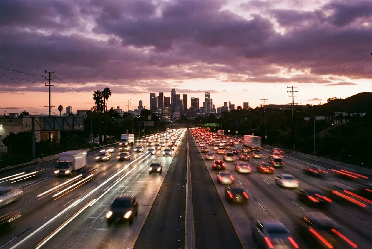 Aerial view of Los Angeles evening traffic on freeway at sunset