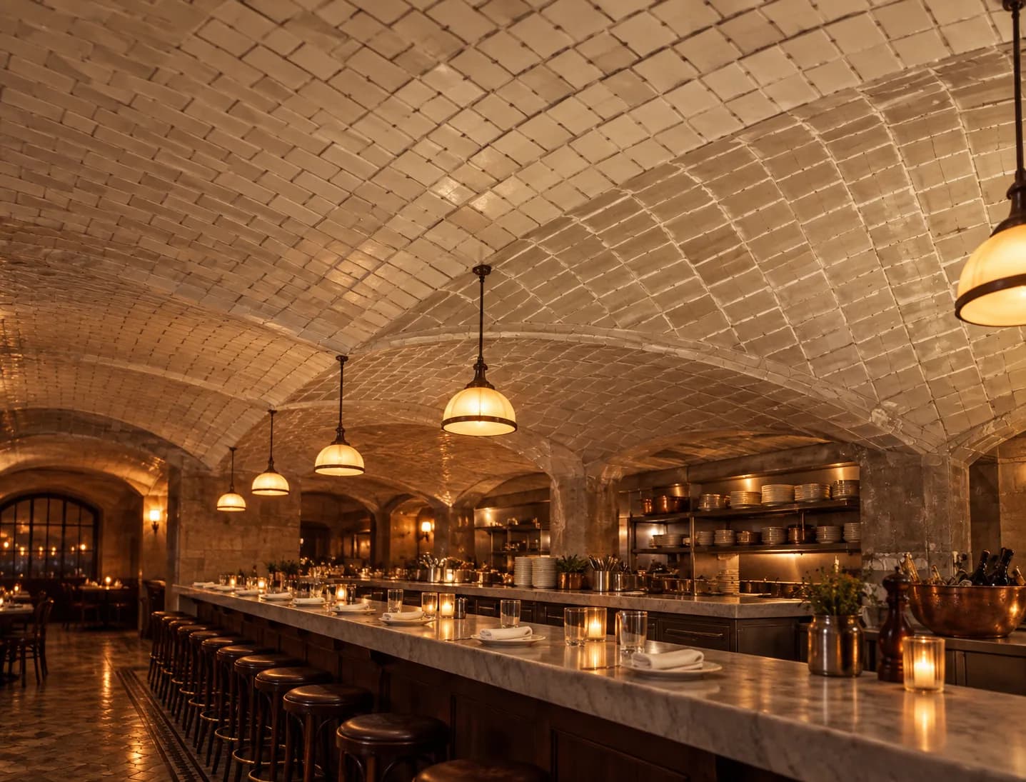 A vaulted ceiling of interlocking pale tiles curving low over a restaurant counter, with lamps hanging beneath