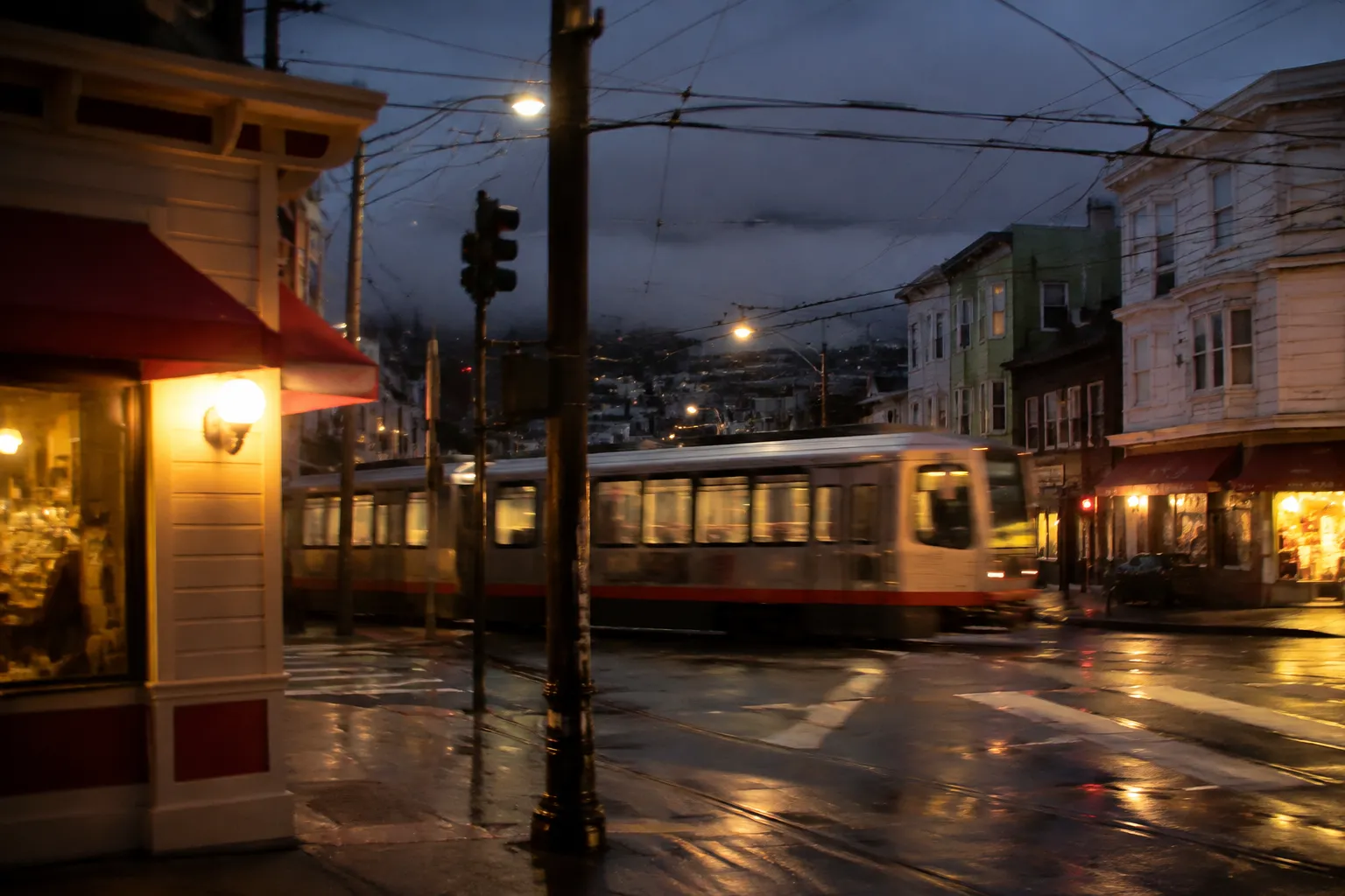 Irving Street in the Sunset District at dusk with fog and lit storefronts
