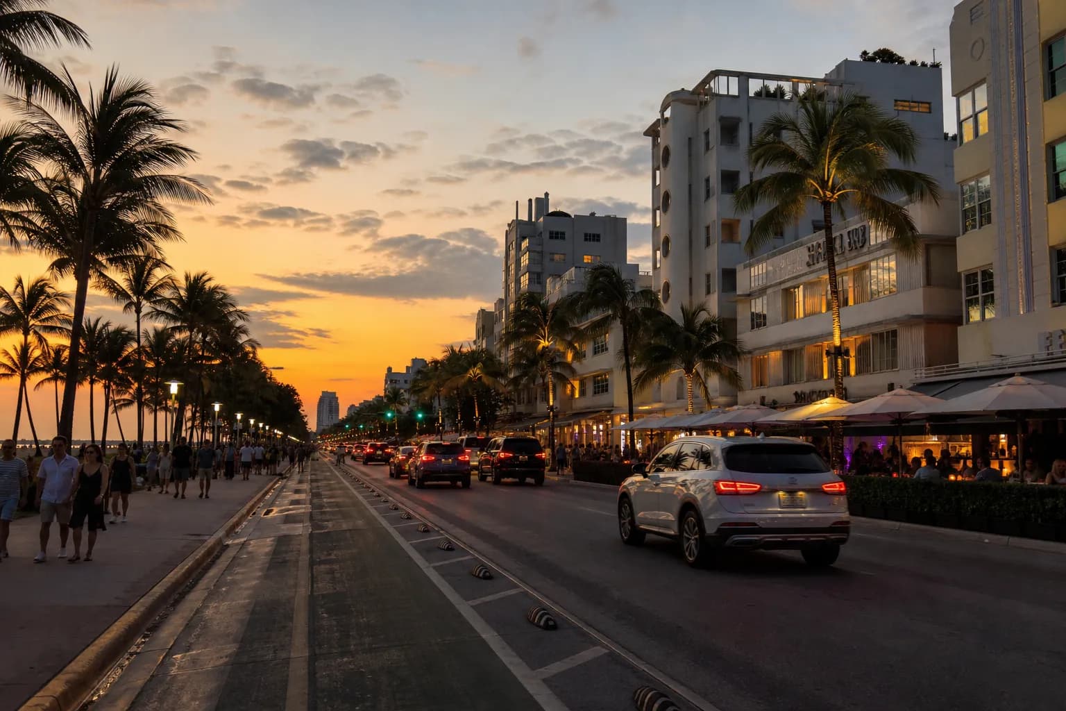 South Beach street view at sunset with hotel towers and palm-lined blocks