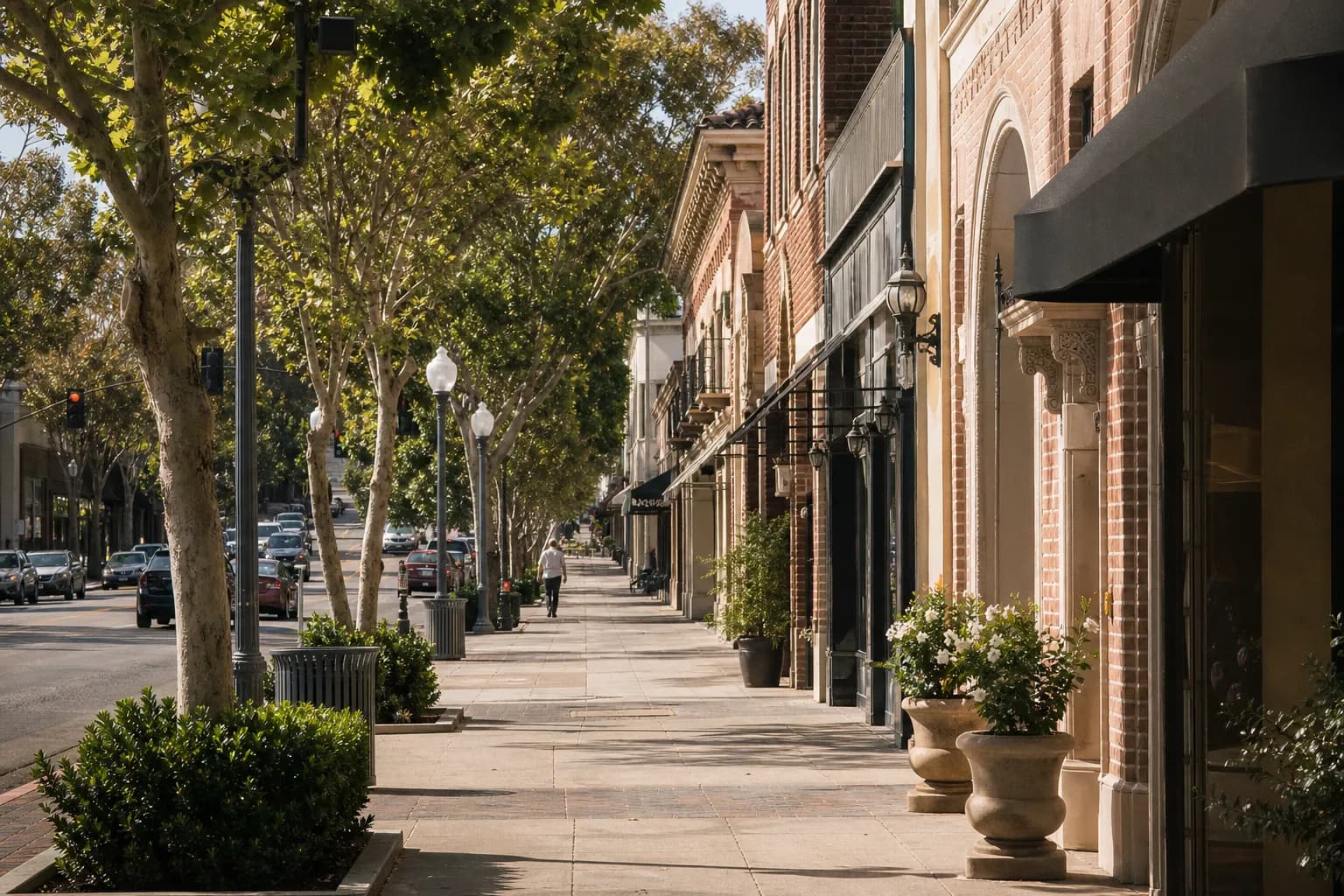 Quiet Pasadena street with historic storefronts and cafe awnings in morning light