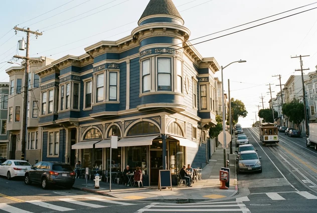A Victorian corner building in San Francisco with a cafe on the ground floor in morning light
