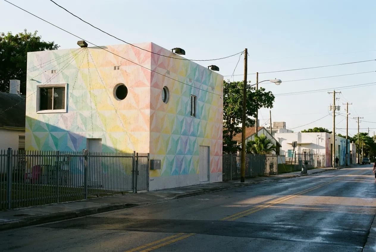 Low warehouse buildings along a quiet Wynwood street in early morning light