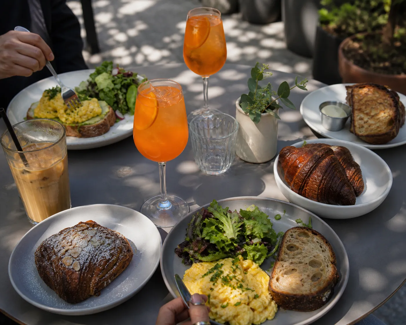 Brunch plate with eggs, toast, and coffee on a sunny table