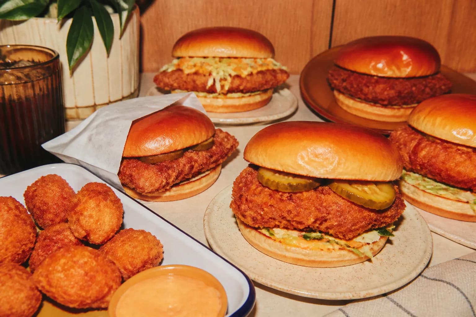 An assortment of breaded chicken sandwiches and golden nuggets arranged on a table