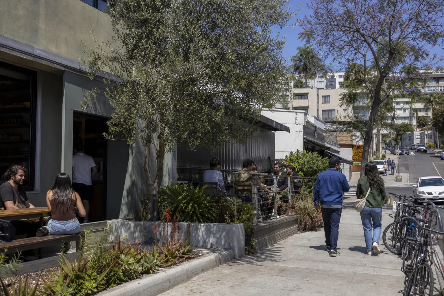 Sunlit Silver Lake coffee shop storefront with sidewalk seating on a spring afternoon