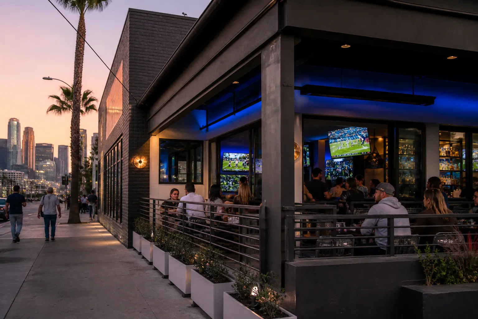 Los Angeles sports bar patio with big screens and Dodgers colors at dusk