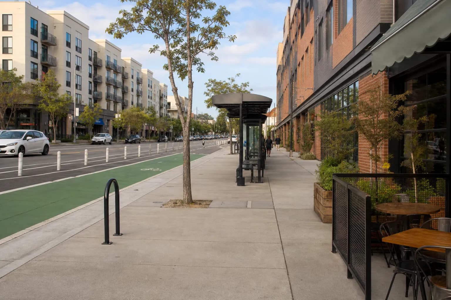 Los Angeles neighborhood street with bus stop, bike lane, and apartments
