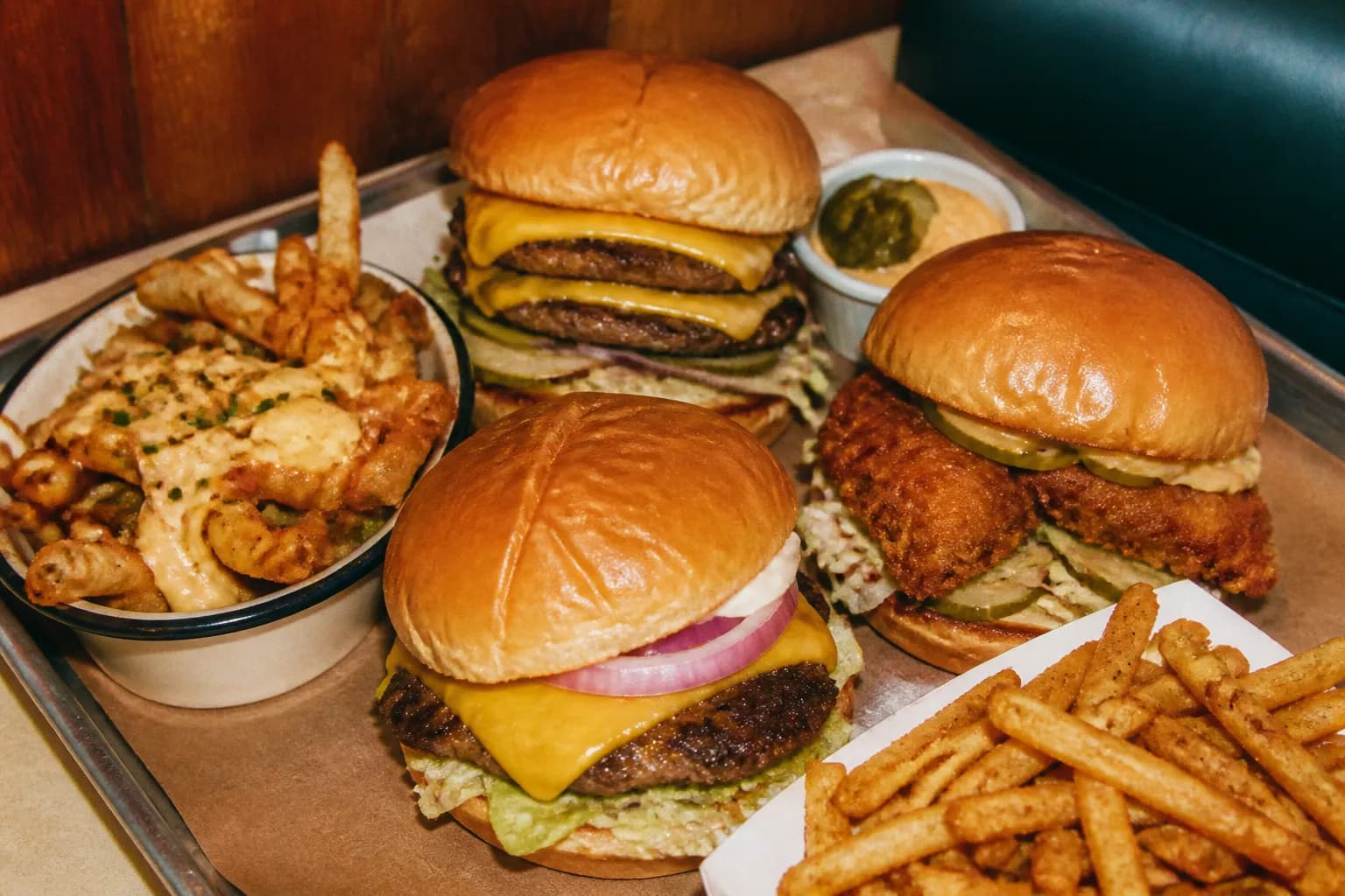 An assortment of burgers and fries arranged together on a tray