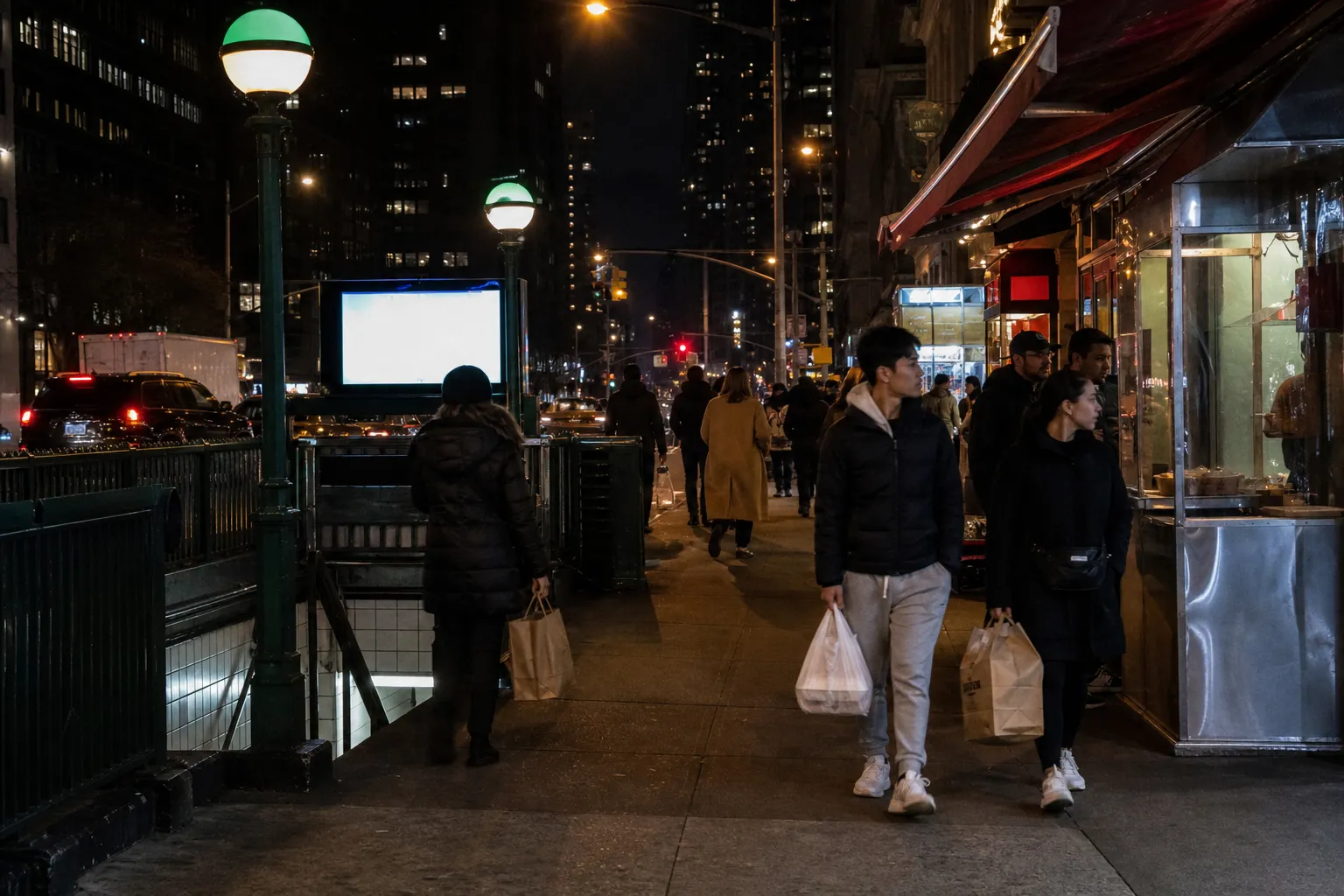 A subway entrance near late-night food storefronts in New York