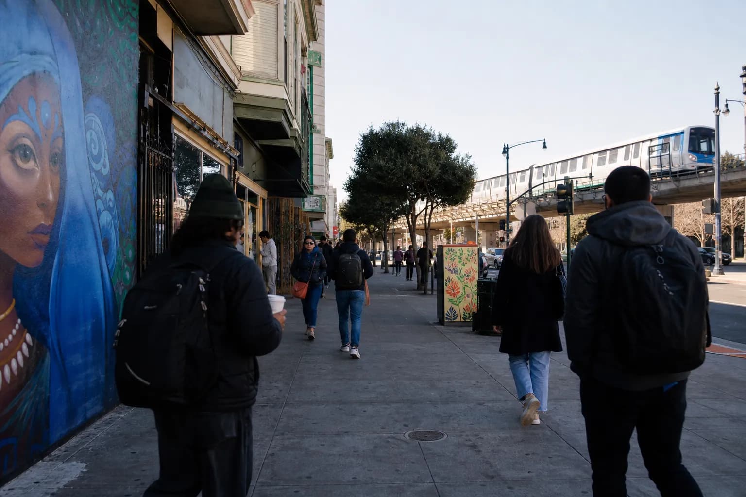BART access and a busy Mission street scene near a ceramics studio storefront.