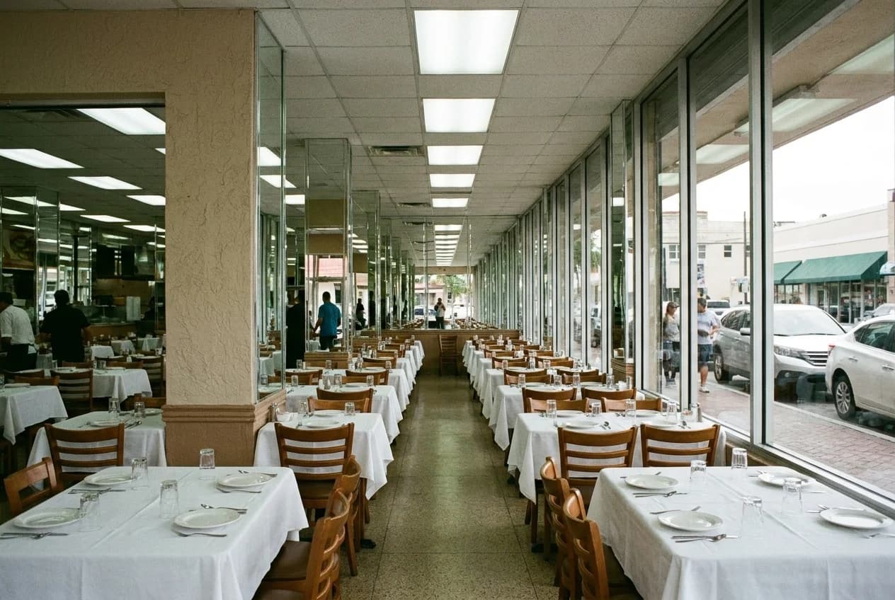 Mirrored dining room interior at Versailles Cuban restaurant in Little Havana with white tablecloths and rows of tables