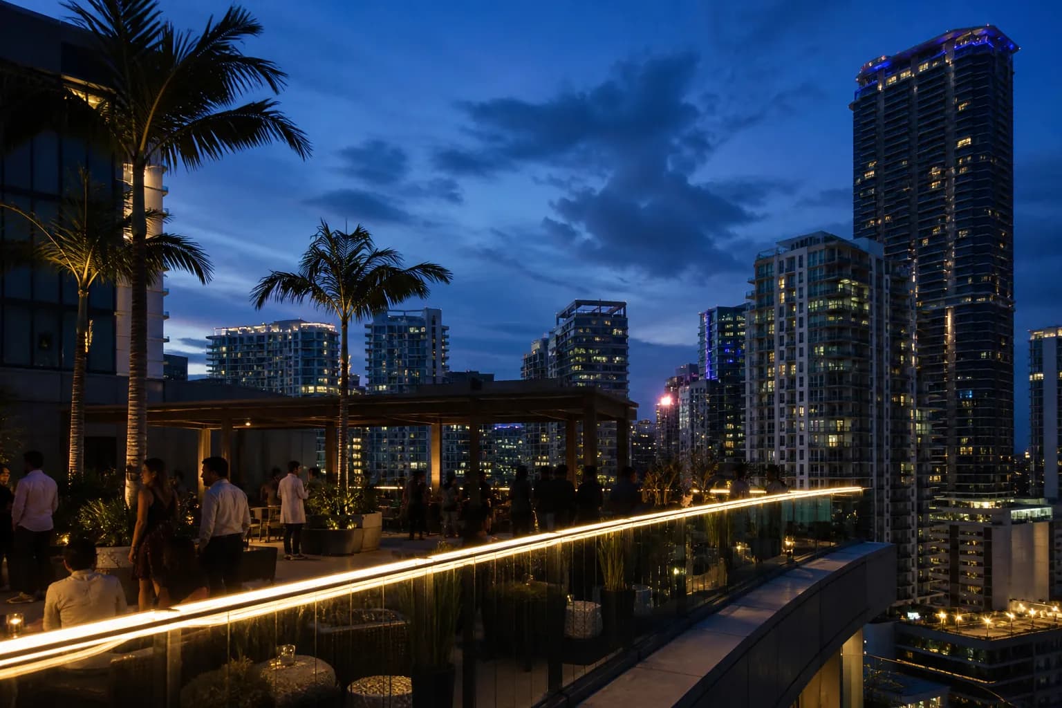 Blue hour view of a Brickell rooftop bar with city lights