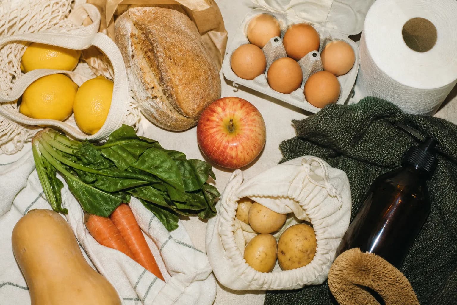 A flat lay of everyday grocery and household goods arranged neatly on a surface