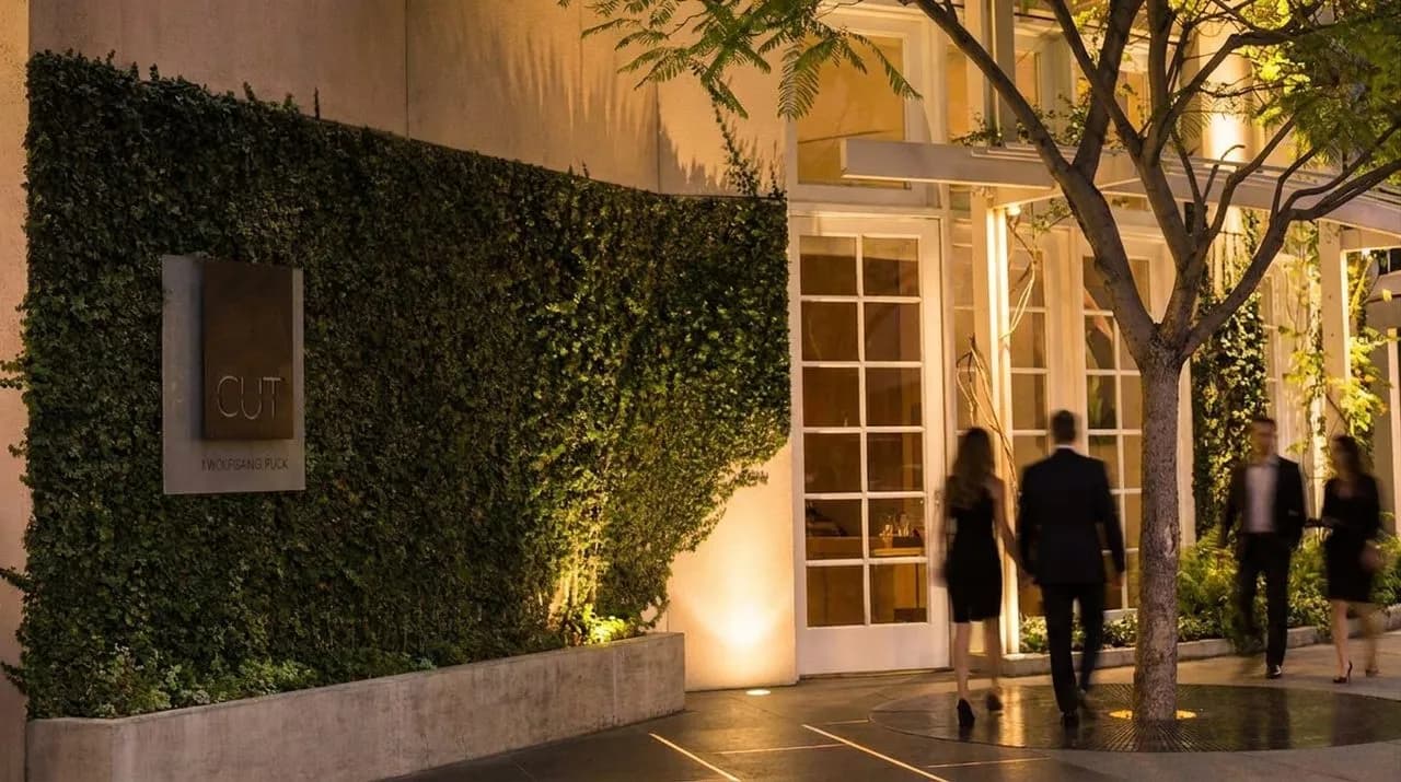 A sleek Beverly Hills steakhouse entrance at night.