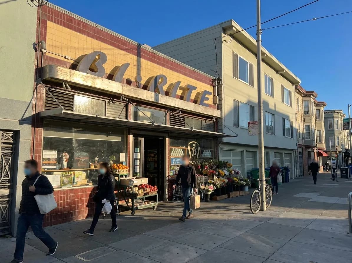 Bi-Rite Market's 18th Street storefront in San Francisco's Mission District with pedestrians passing by