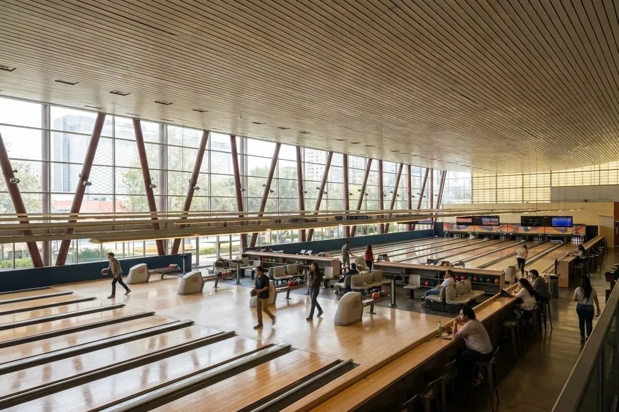 Wide interior view of a San Francisco bowling and skating center with lanes and open recreation space