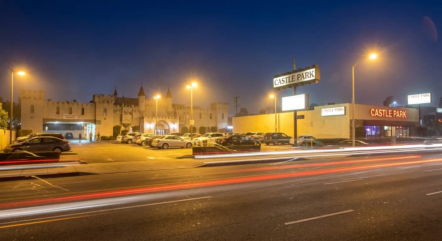 Exterior view of Castle Park on Sepulveda Boulevard at night, showing lit signage and parking lot entrance.