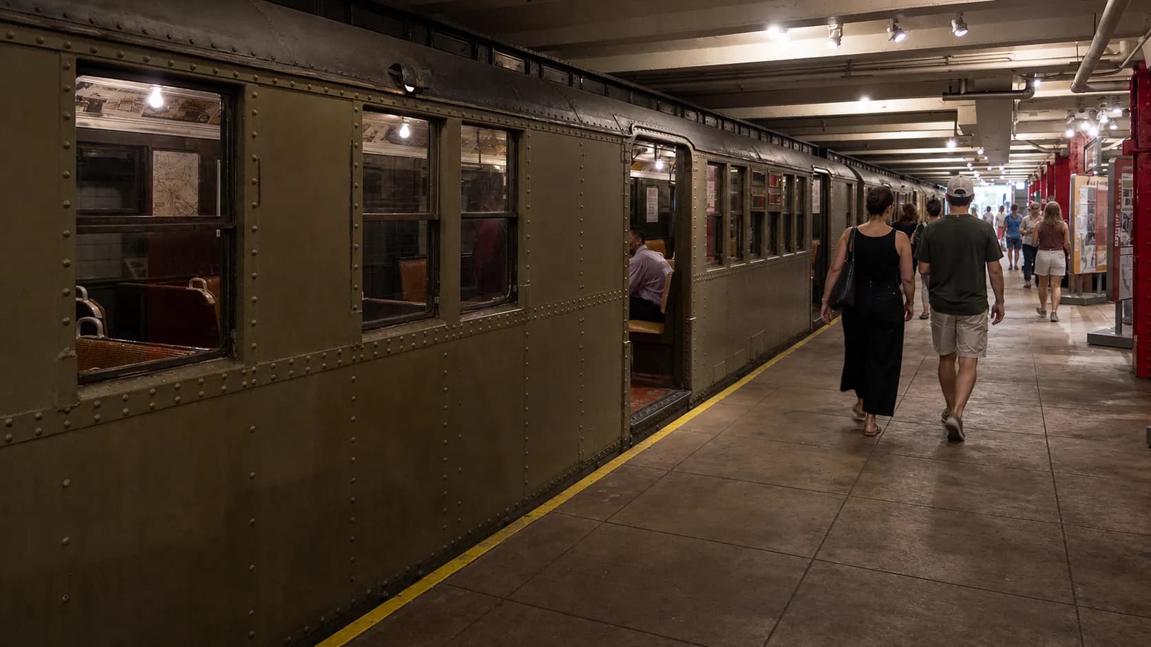 A New York City subway entrance with pedestrians heading toward nearby museums.