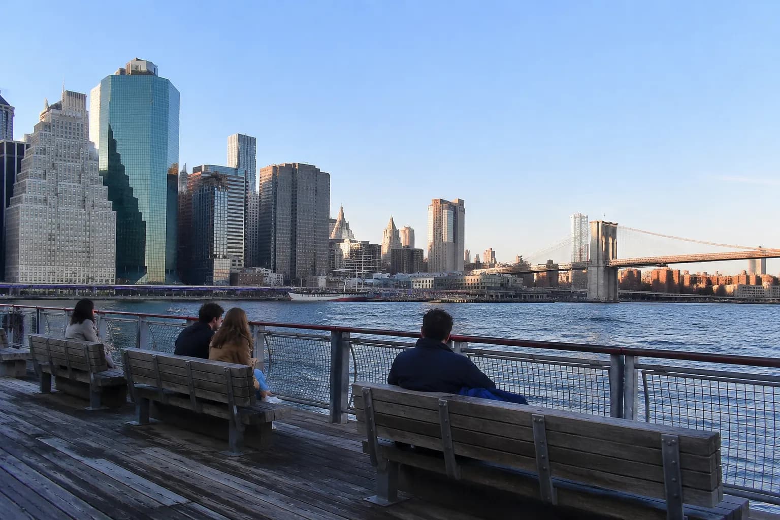 View of the Brooklyn Bridge and East River from Pier 15 at South Street Seaport in late afternoon