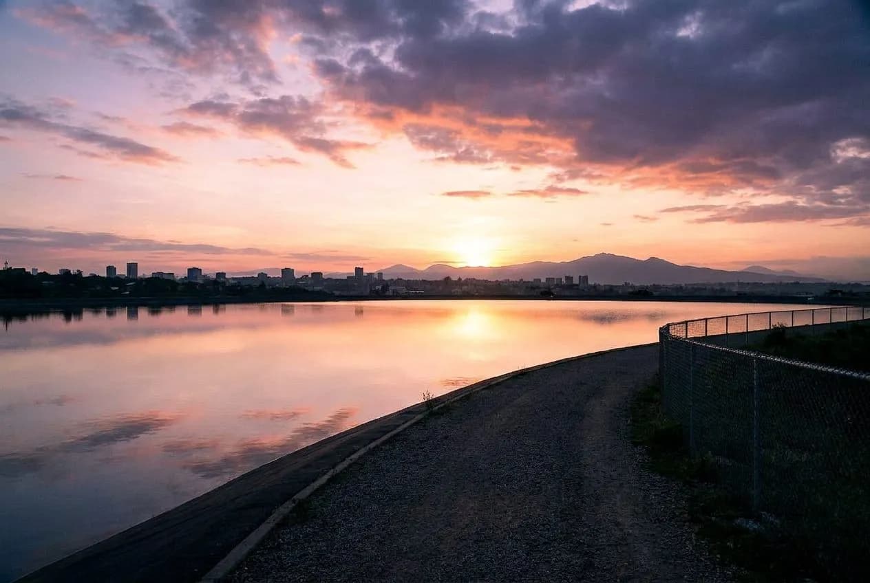 the central park reservoir running path when the first light hits the water