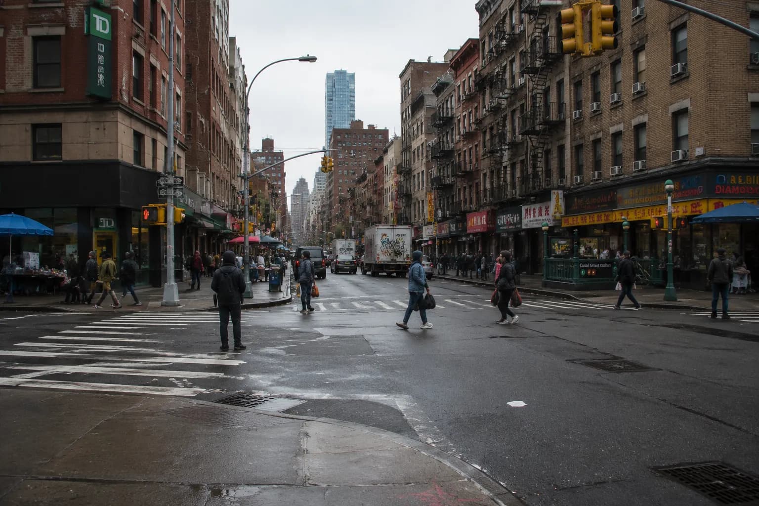 Canal Street in Chinatown showing pedestrian traffic and subway entrance