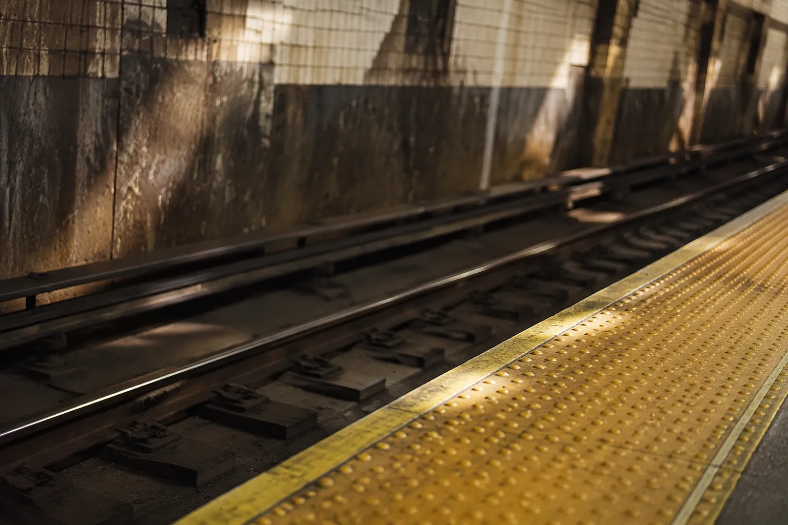 New York City subway platform showing track and safety stripe