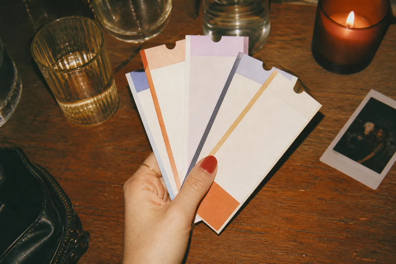 Several concert tickets fanned out across a wooden table