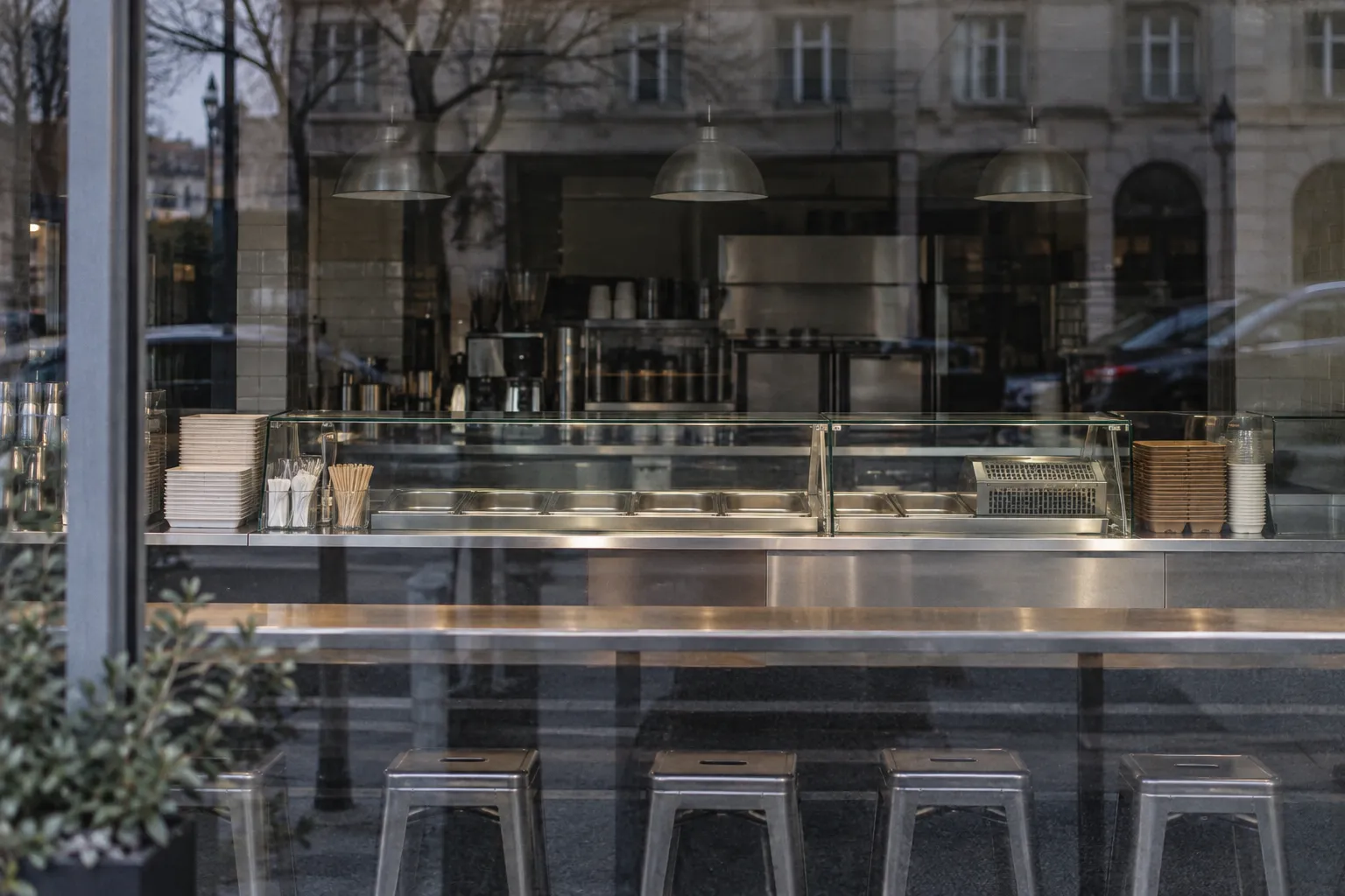An empty fast-casual counter seen through glass in daylight
