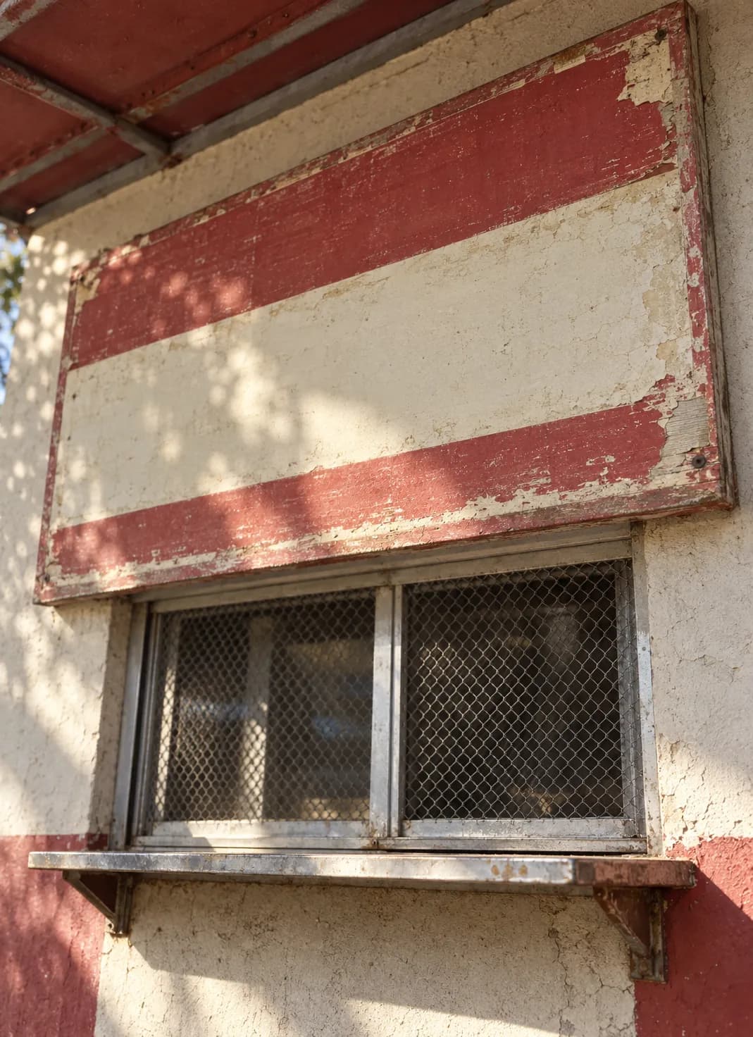 A hand-painted menu board mounted above a service window